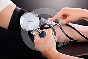 Doctor Checking Blood Pressure Of Patient