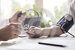 Doctor measuring blood pressure of patient