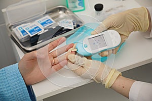 Doctor checking blood sugar level. doctor patient diabetes lancet glucometer blood glucose office concept