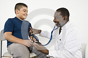 Doctor Checking Boy's Blood Pressure