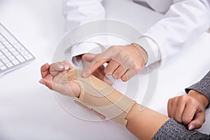 Doctor Checking Fractured Hand Of A Woman