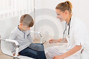Doctor Checking Knee Reflex On Child Patient