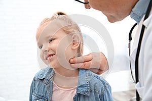 Doctor checking little girl`s pulse with fingers