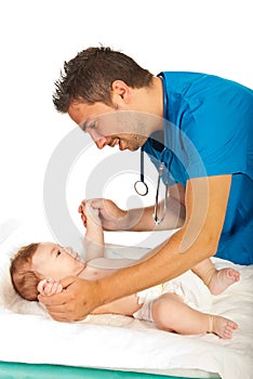 Doctor checking locomotor skills to baby