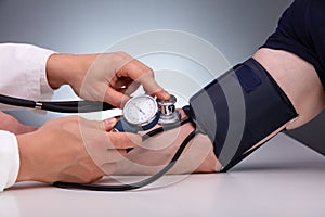 Doctor Checking Male Patient Arterial Blood Pressure