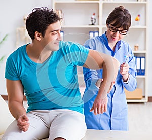 Doctor checking nerve reflexes with hammer