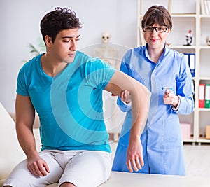 Doctor checking nerve reflexes with hammer