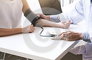 Doctor checking old woman patient arterial blood pressure. Health care.