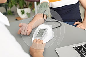 Doctor checking patient`s blood pressure