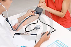 Doctor checking patient`s blood pressure