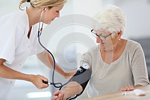 Doctor checking on patient's blood pressure