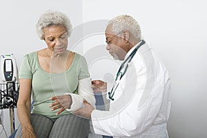 Doctor Checking Patient's Fractured Hand photo