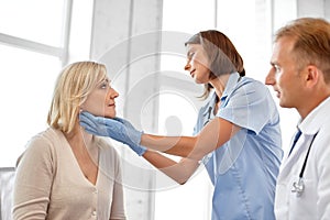 Doctor checking patient`s tonsils at hospital