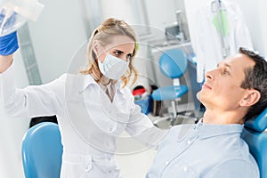 Doctor checking patient teeth in modern