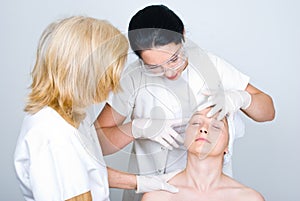 Doctor checking patient woman skin photo