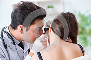 The doctor checking patients ear during medical examination