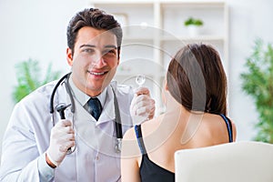 The doctor checking patients ear during medical examination