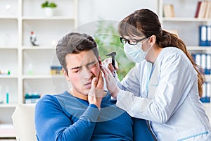 The doctor checking patients ear during medical examination