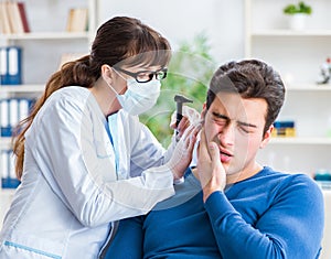 Doctor checking patients ear during medical examination