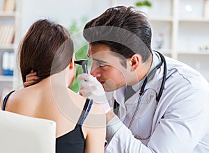 Doctor checking patients ear during medical examination