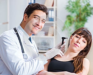 Doctor checking patients ear during medical examination