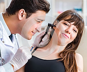 Doctor checking patients ear during medical examination