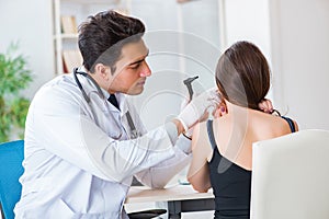 The doctor checking patients ear during medical examination