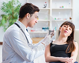 Doctor checking patients ear during medical examination