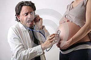 Doctor checking a pregnat woman's health photo