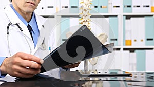 Doctor checking x ray, medical and radiology concept