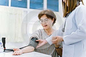 doctor checking senior patient blood pressure. Health care