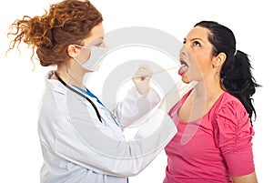 Doctor checking for sore throat