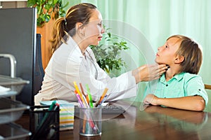 Doctor checking thyroid of teenager