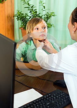 Doctor checking thyroid of teenager