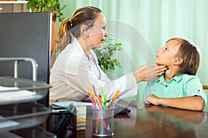 Doctor checking thyroid of teenager