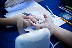 Doctor checking woman patient arterial blood pressure, Health ca