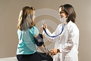 Doctor Checks Girl's Heartbeat. Horizontal