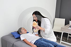 Doctor checks her patient with autism ASD, with teddy bear that she carries as an attachment or transitional object