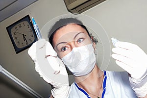 Doctor checks the syringe before the injection