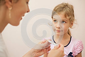 Doctor checks the temperature of girl