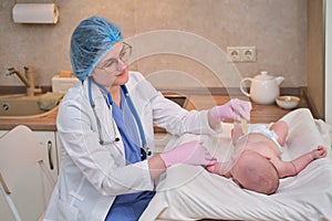 Doctor checks the throat of a newborn child with a plowshare. A nurse in uniform with a wooden stick in her hand examines the