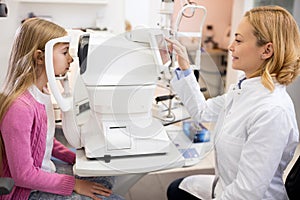 Doctor checkup eyesight of girl on ophthalmologist