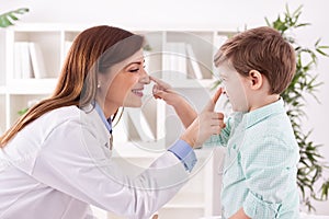 Doctor and child enjoy and playing together touching noses