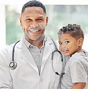 Doctor, child and happy portrait for health care in hospital with a smile at a consultation. Face of black man or