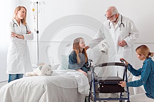 Doctor and child on the hospital bed