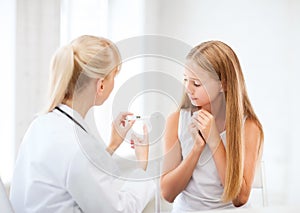 Doctor with child measuring temperature