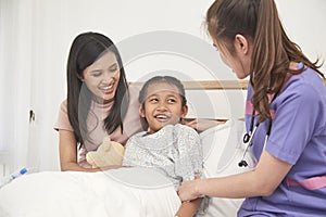 Doctor and child with mother in hospital