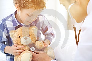 Doctor and child patient. Physician examines little boy by stethoscope. Medicine and children`s therapy concept