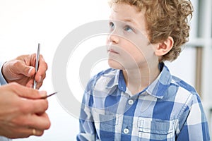 Doctor and child patient. Physician examines little boy by stethoscope. Medicine and children`s therapy concept