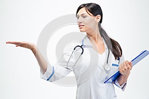 Doctor with clipboard holding copyspace on her palm